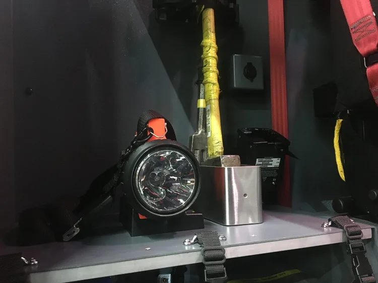 Open compartment close-up showing mounted flashlight and small tools