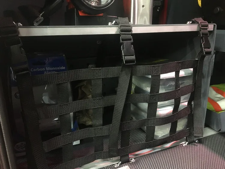 Open compartment close-up showing secured equipment bag and strap mounts