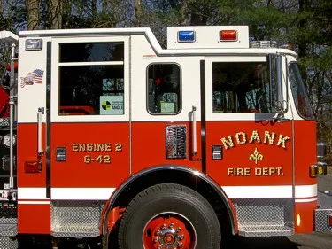 Driver-side cab close-up showing front wheel area and door lettering