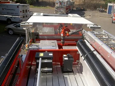 Overhead hosebed view showing deck gun and hose storage channels