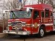 Front-left thumbnail view of the pumper parked beside the Pierce sign.