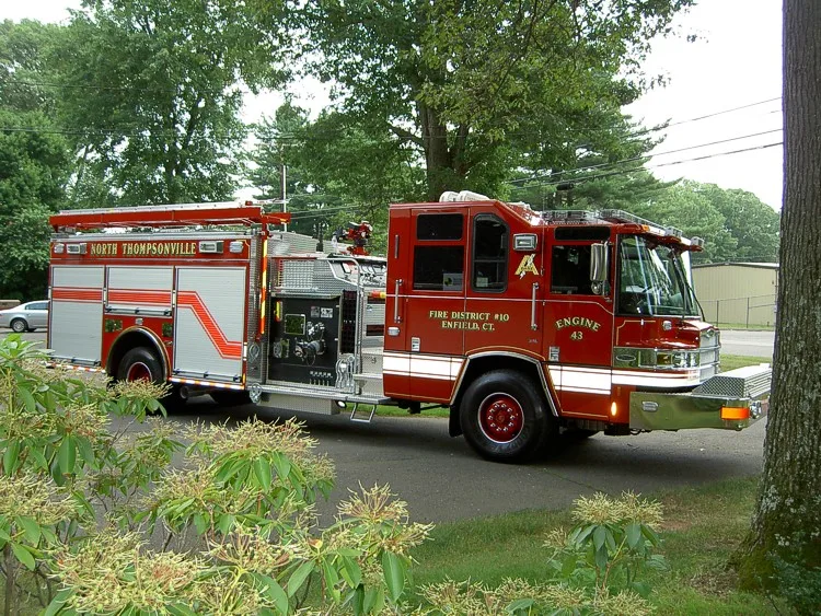 Driver-side profile view showing side compartments and pump panel area