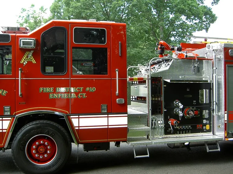 Cab and pump panel close-up showing gauges, valves, and control levers