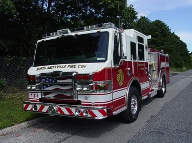 Front-left three-quarter view showing the chrome grille, cab, and side body compartments.