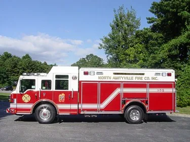 Driver-side profile view showing long rescue body and side compartments