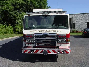 Front exterior view showing grille, bumper, and warning lights