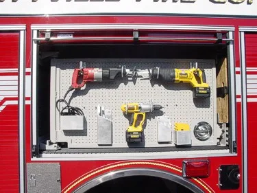 Open side compartment showing rotary saw, cordless drill, and mounted tools