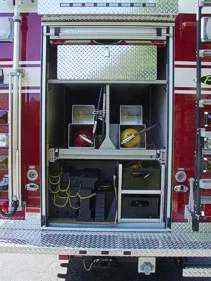 Open rear compartment view showing shelves, bags, and small equipment