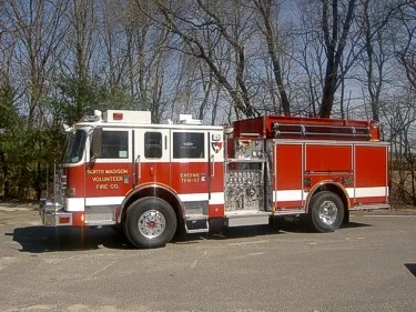 Driver-side profile view showing pump panel area and side compartments