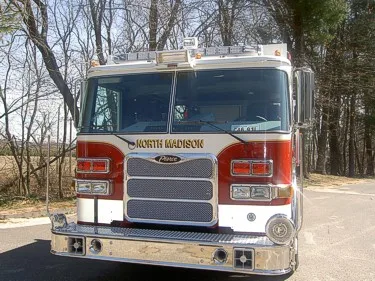 Front exterior view showing grille, bumper, and warning lights