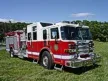 Wide front left view of the parked pumper showing bumper, cab, and full body profile.