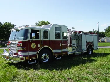 Front right angle showing cab doors, pump panel section, and rear body compartments.