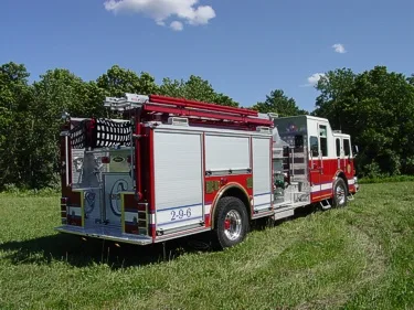 Rear right side view showing hosebed area, side roll-up doors, and rear wheel section.