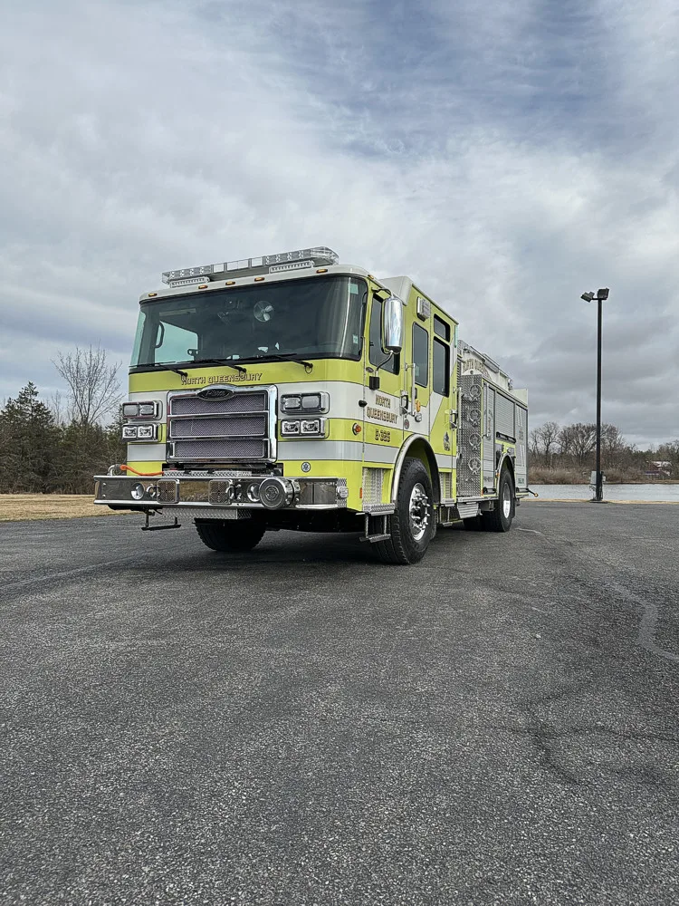 Front-right exterior wide view showing pumper under cloudy sky