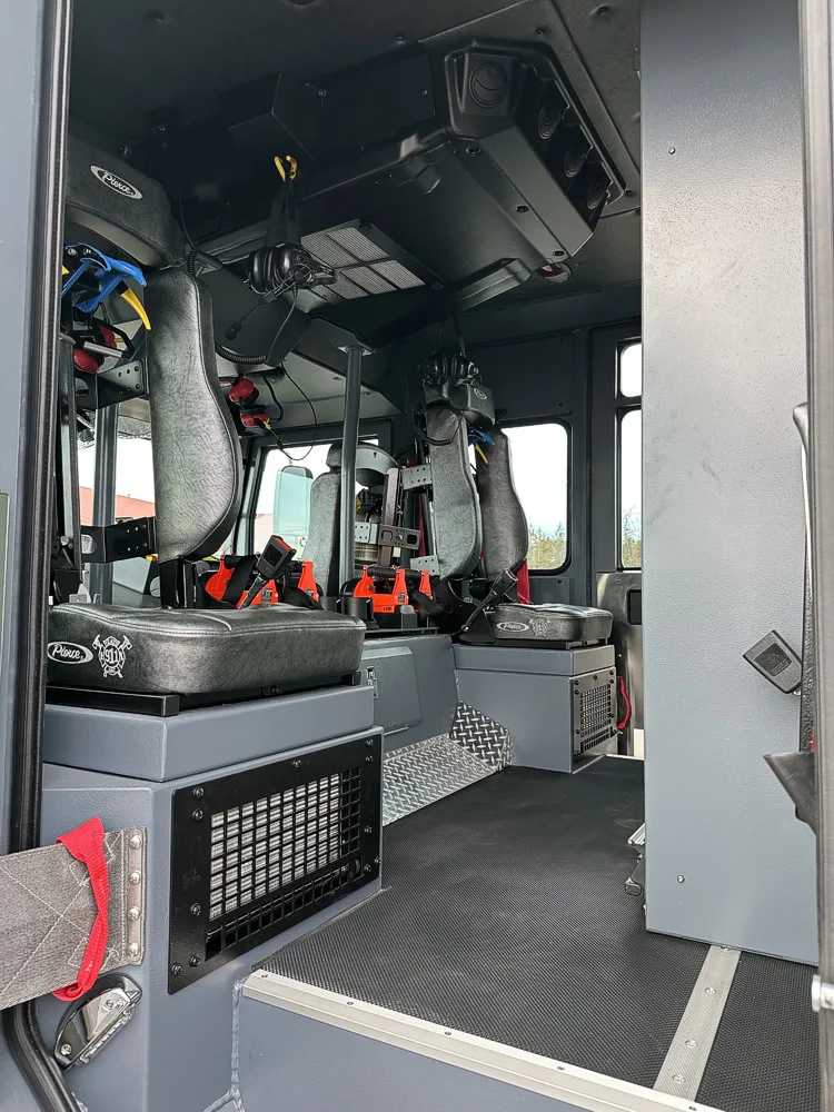 Rear crew seating view showing SCBA seats, harnesses, and raised floor walkway