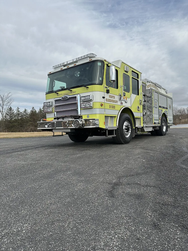 Front-right exterior wide shot showing pumper parked on asphalt lot