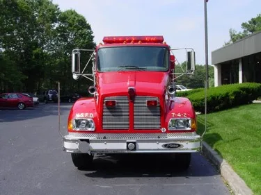 Front exterior view showing grille, bumper, and warning lights