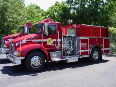 Driver-side pump panel view showing gauges, valves, and side controls