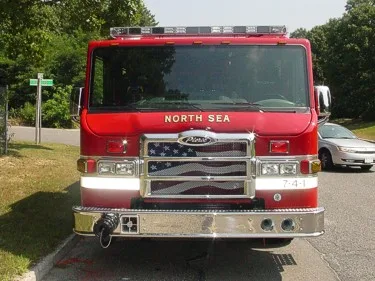 Head-on front view showing windshield, flag-style grille, warning lights, and front intake ports.