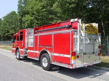 Rear right side view showing roll-up compartments, hose load on top, and rear wheel area.