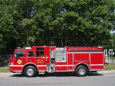 Full right-side profile showing pump panel location, side compartments, and wheel/tire layout.