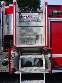 Open side compartment close-up with pull-down tray, panel controls, and mounted equipment space.