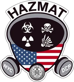 Close-up of a hazmat shield-style emblem with safety symbols and circular side initials.