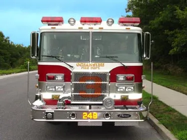 Head-on front view showing grille, bumper, and warning lights