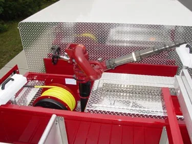 Top deck close-up showing mounted monitor piping and hosebed hardware