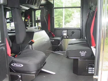 Cab interior side view showing rear seats and center aisle