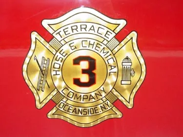 Cab door close-up showing circular company crest on red panel