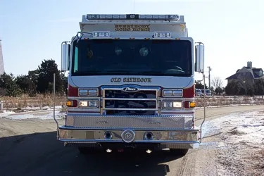 Head-on front view showing the grille, windshield, roof warning lights, and front bumper.