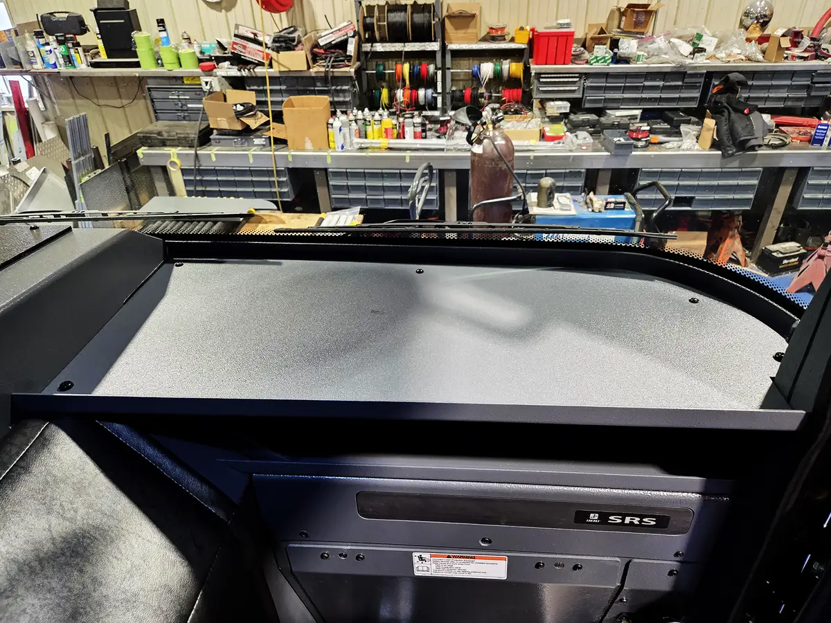 Cab interior console view showing center work surface and cup-holder mounts