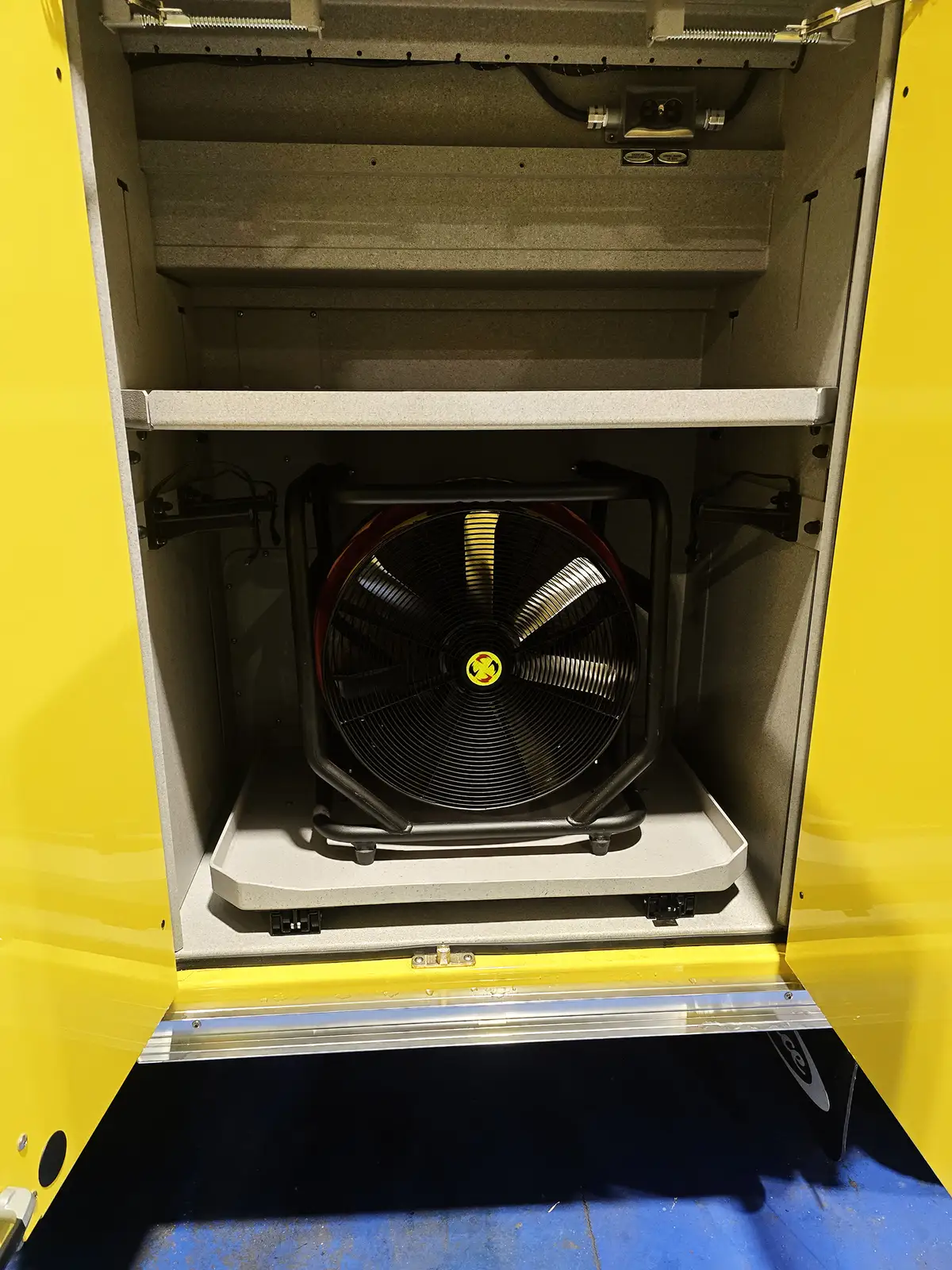 Open side compartment showing a ventilation fan on a slide-out tray