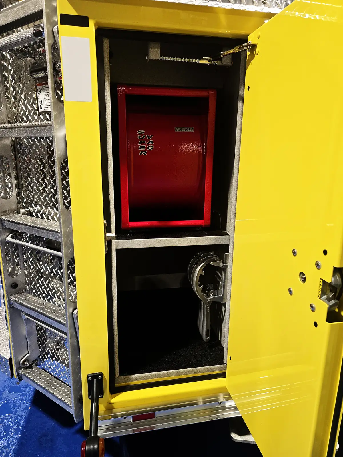 Open vertical compartment showing mounted power unit and lower cable storage