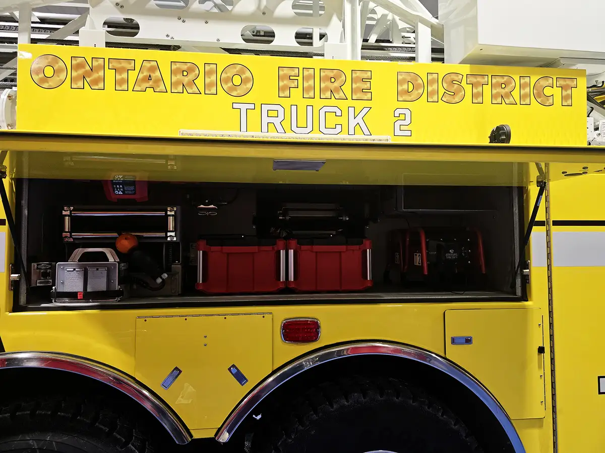 Open upper side compartment showing storage bins and mounted equipment cases