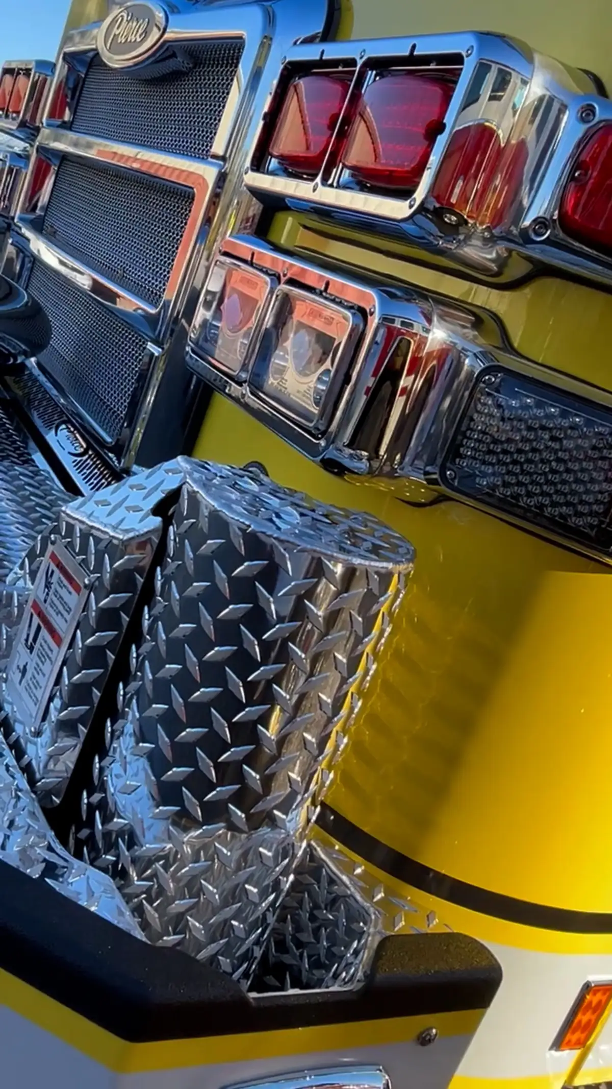 Front bumper close-up showing intake ports, warning lights, and chrome trim