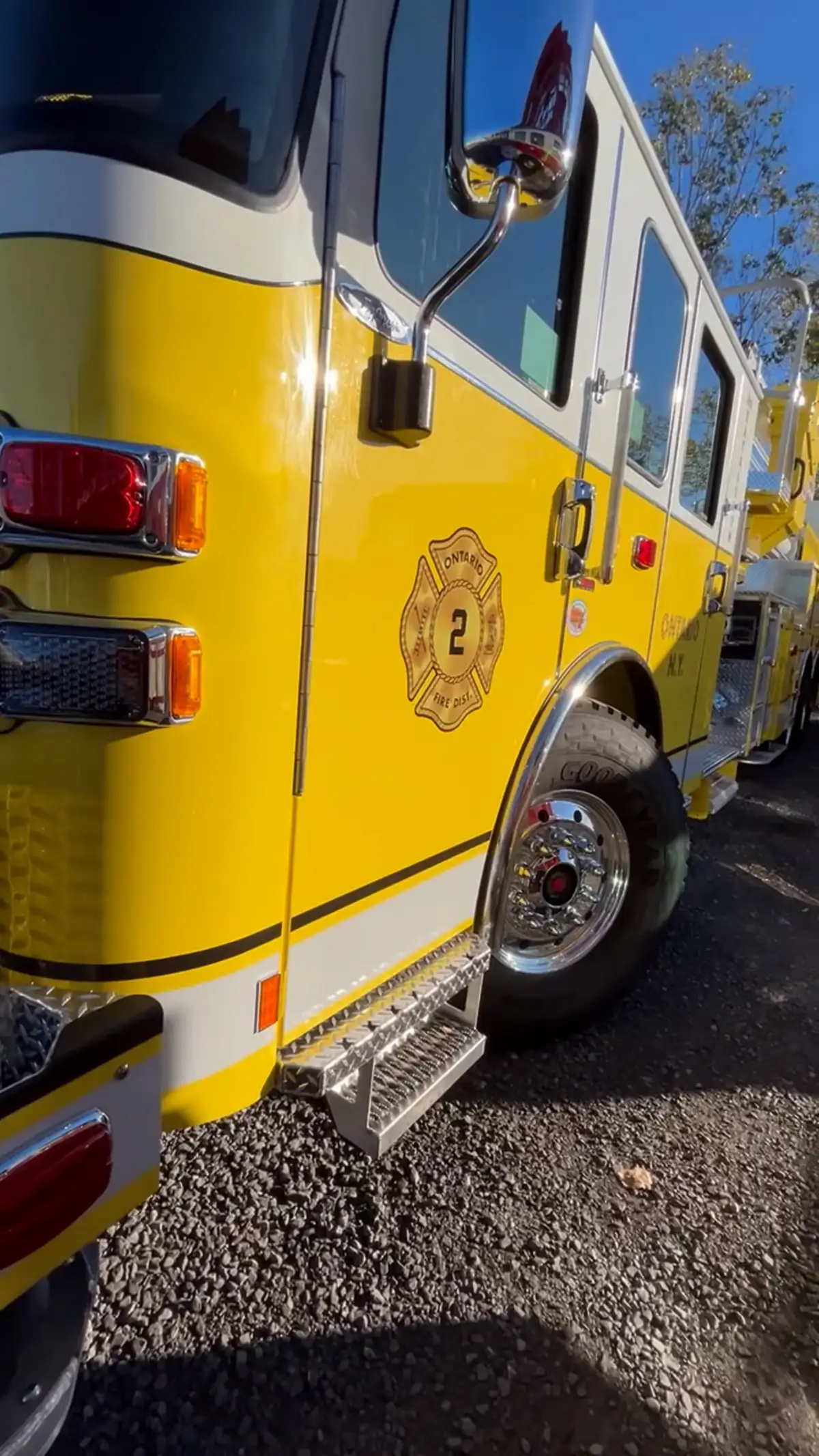 Rear-side close-up showing side body panel, wheel area, and rear light cluster