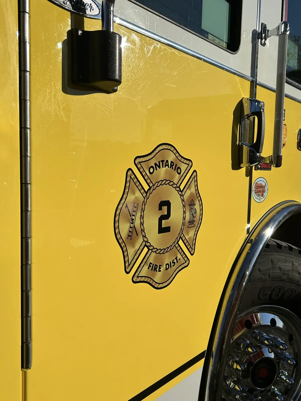 Cab door close-up showing crest logo and black door handle