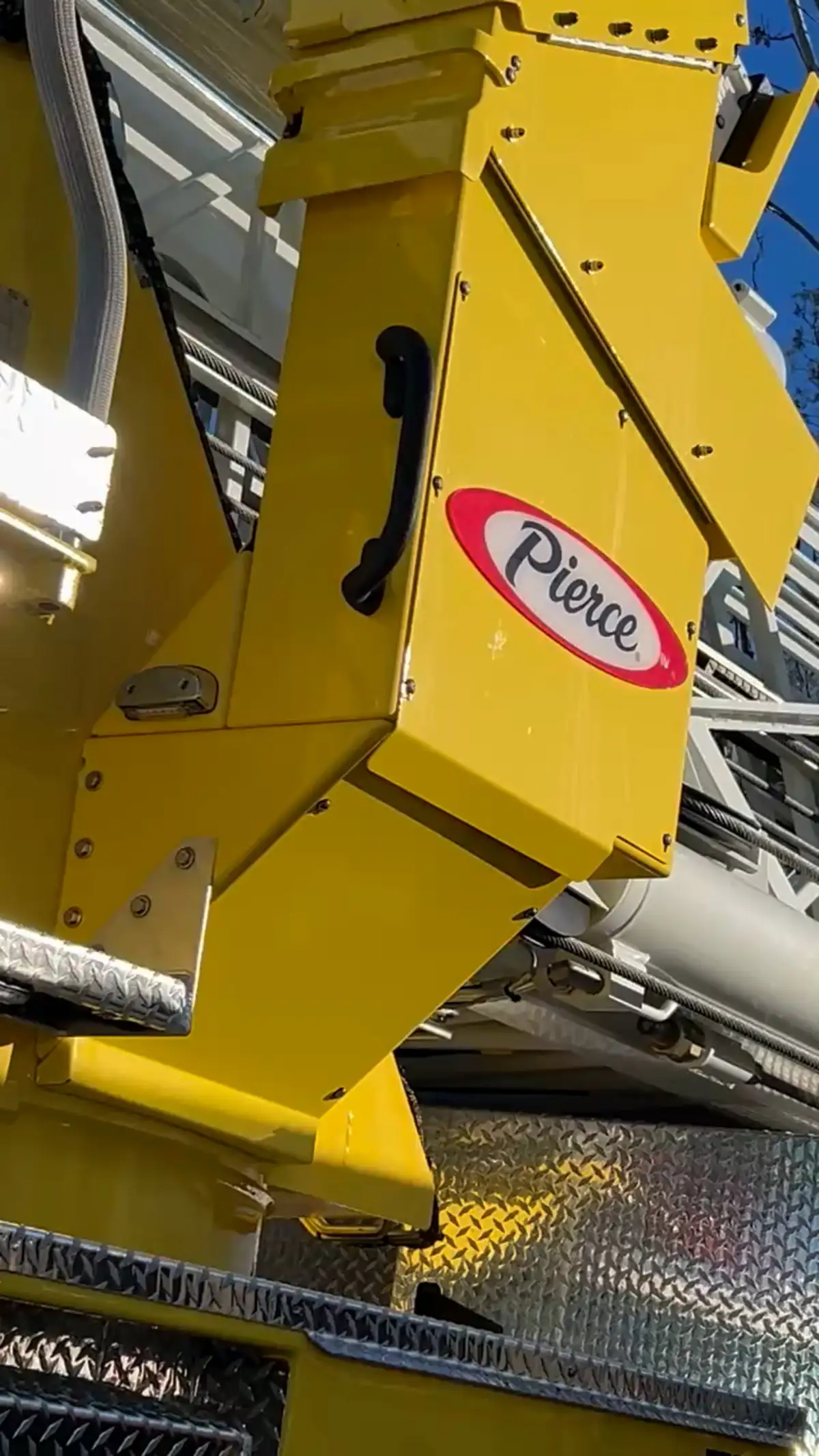 Outrigger close-up showing deployed jack pad and yellow stabilizer arm