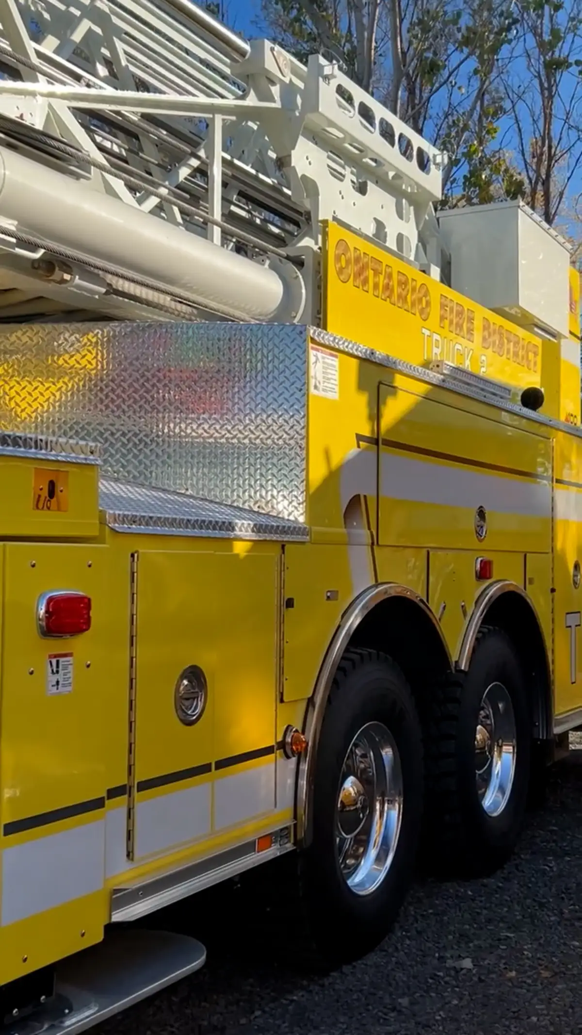 Rear-side wheel area view showing tandem tires and side body panel