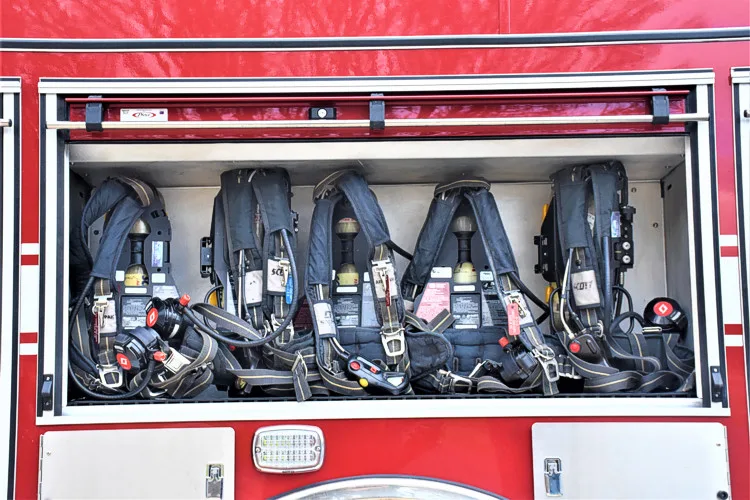 Open side compartment showing mounted SCBA packs and seatback brackets