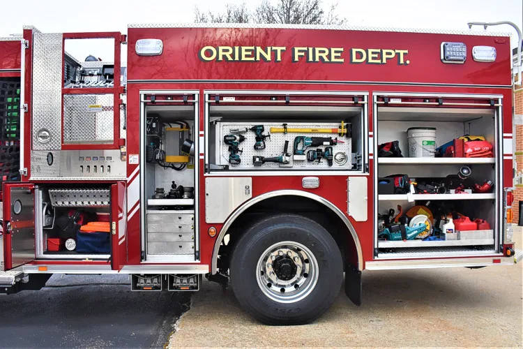 Driver-side profile with open compartments showing full equipment layout