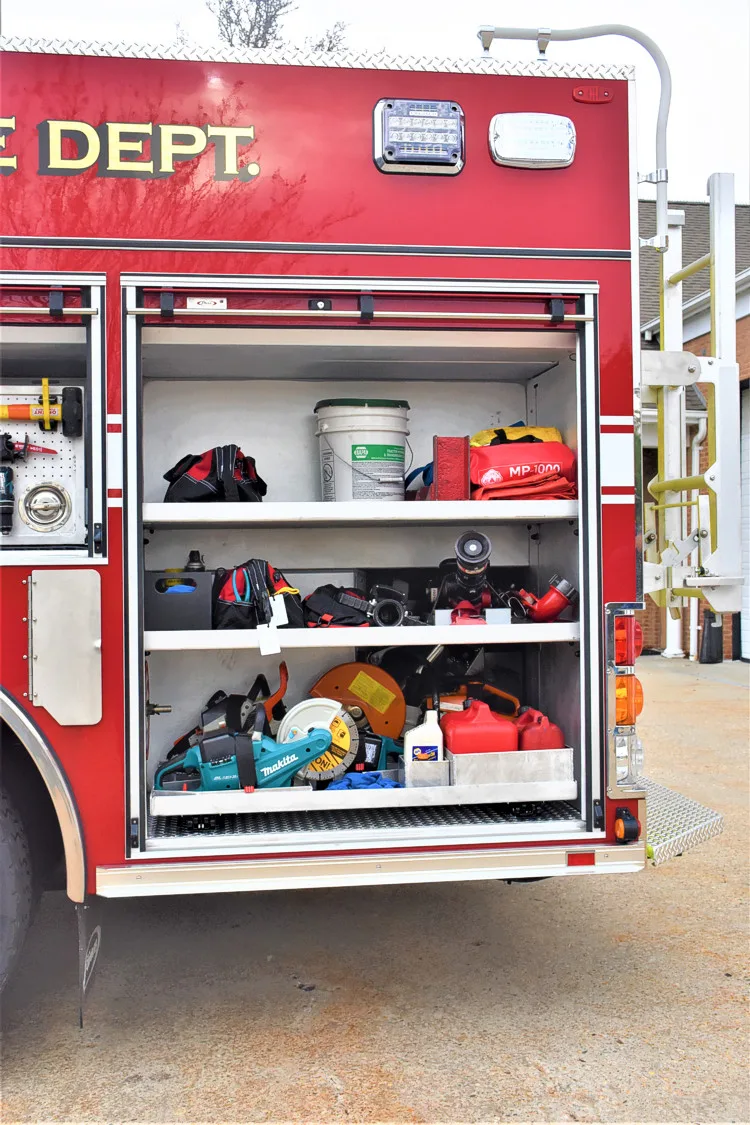 Open side compartment showing bags, helmets, and stacked equipment bins