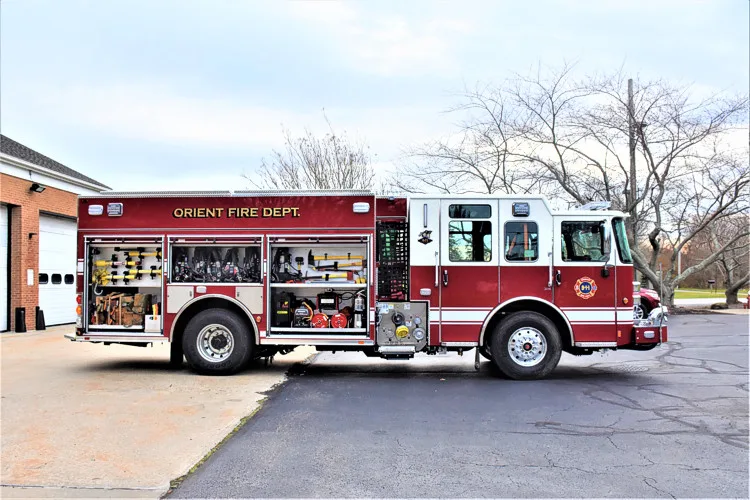 Driver-side profile view with side compartments open and pump-panel area visible