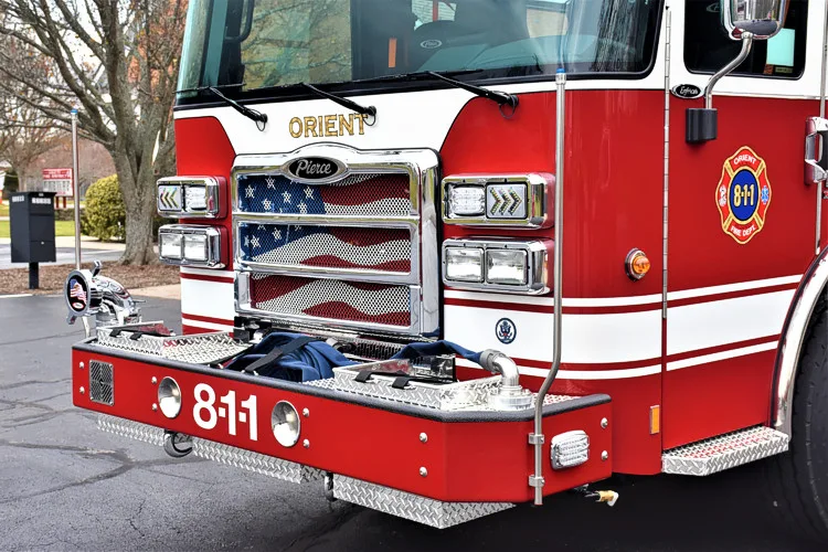 Front bumper close-up showing intake ports, chrome grille, and warning lights