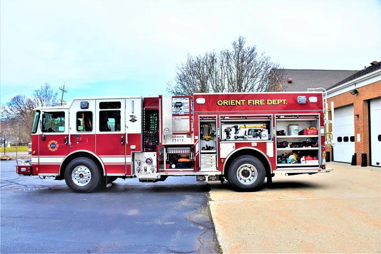 Driver-side profile view showing pumper body and side compartments