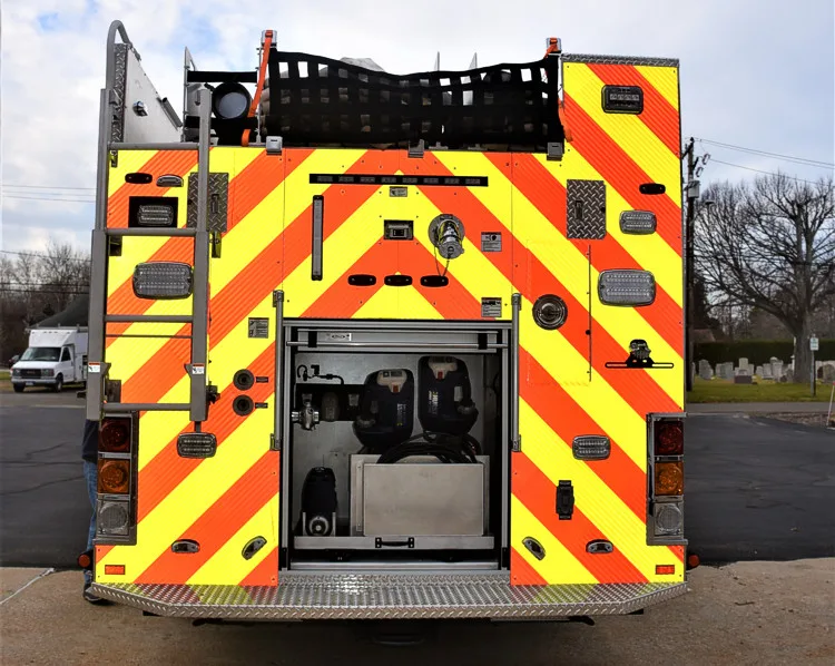 Rear view showing red-and-yellow chevrons and open rear center compartment