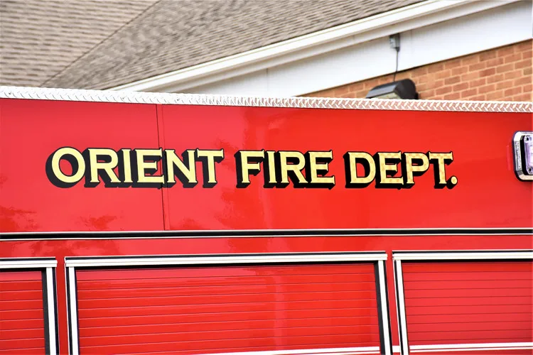 Body side lettering close-up on red panel above roll-up doors