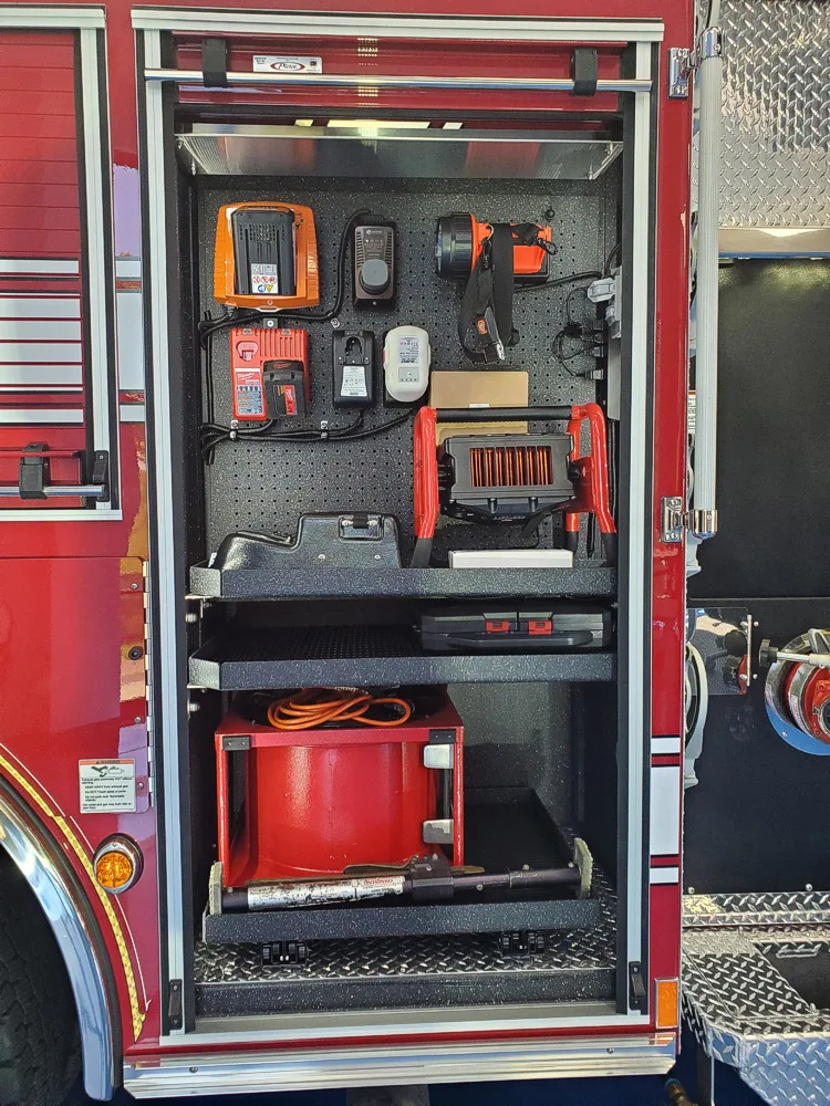 Open side compartment showing generator and tool storage layout